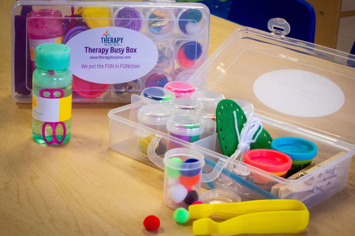 Therapy Busy Box for children opened to show tweezers, sewing activity, play-doh and more fine motor skill activities